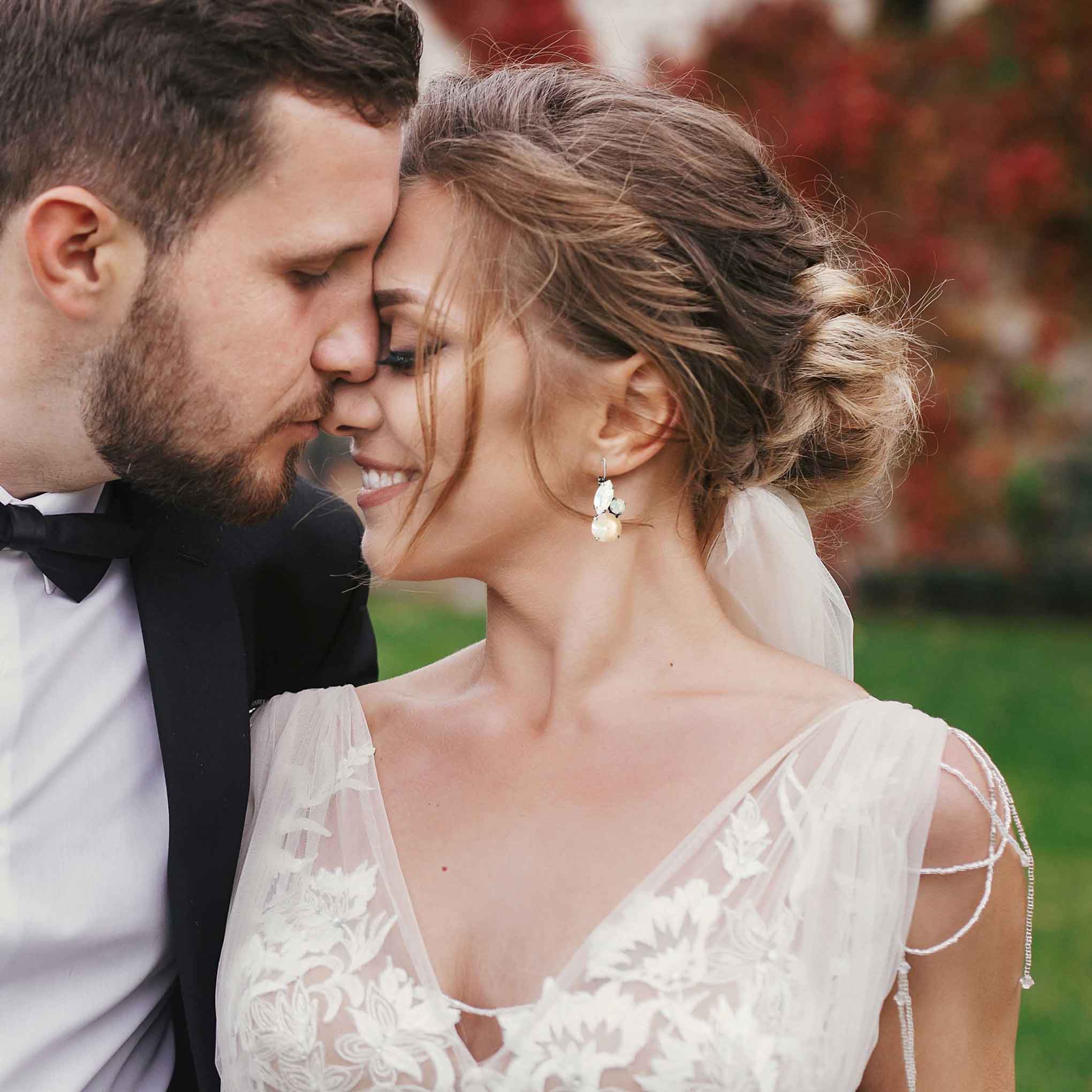 Bride wearing earrings with ivory dress,