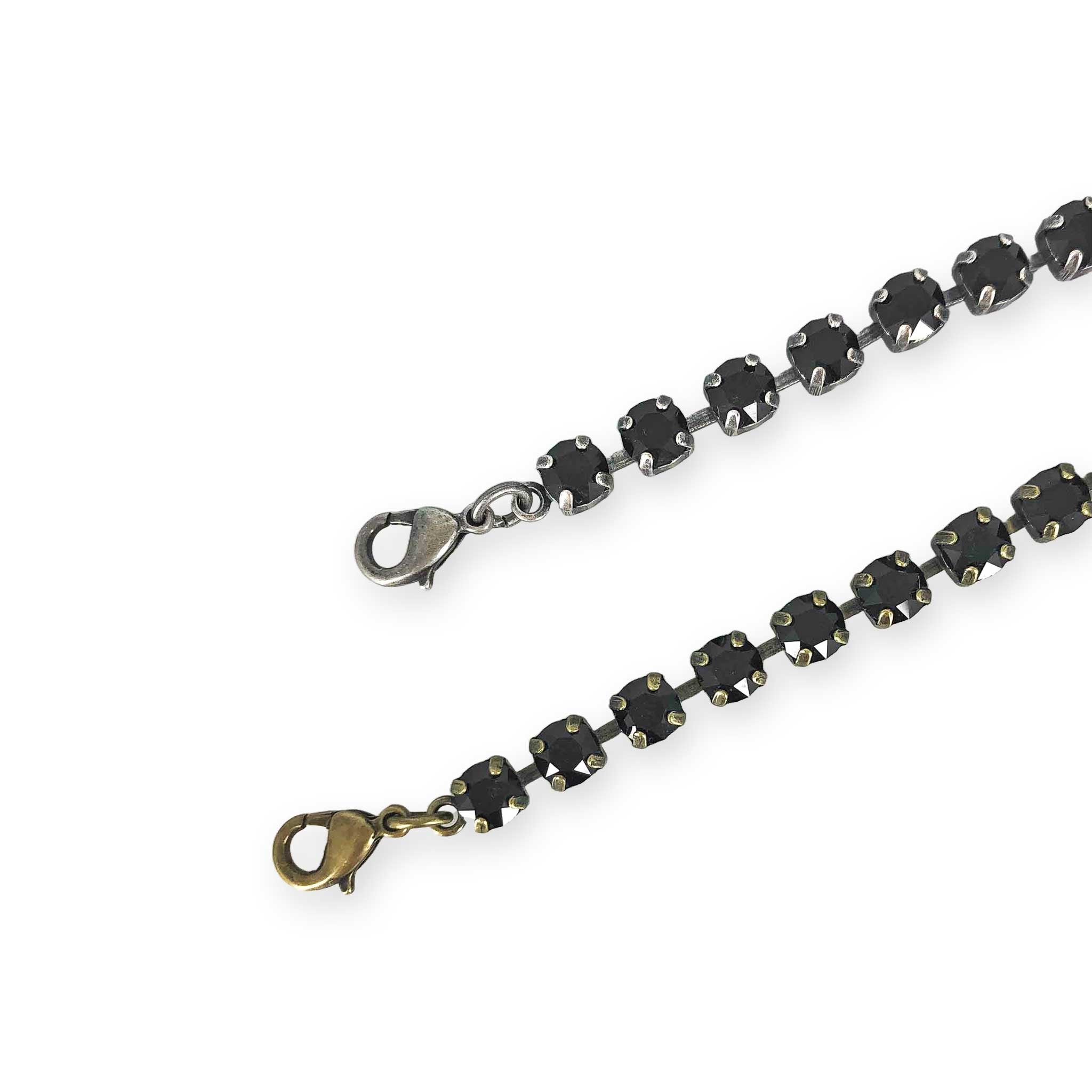 Thin black stone bracelet shown in both antique silver and antique brass.