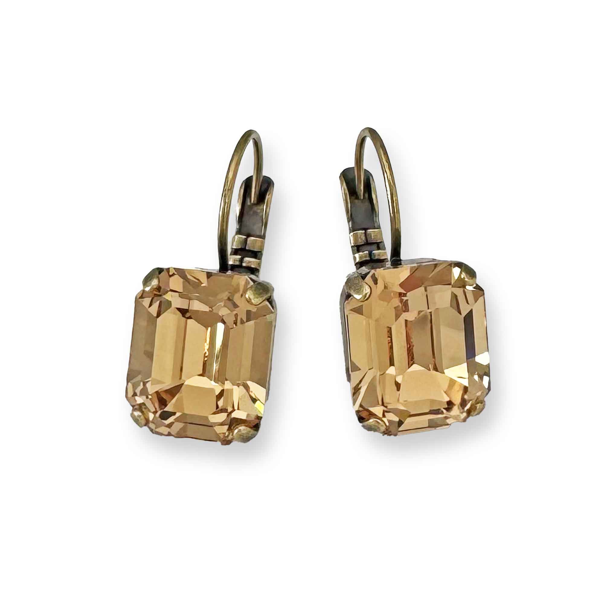Emerald-cut light topaz crystal drop earrings shown in antique brass.
