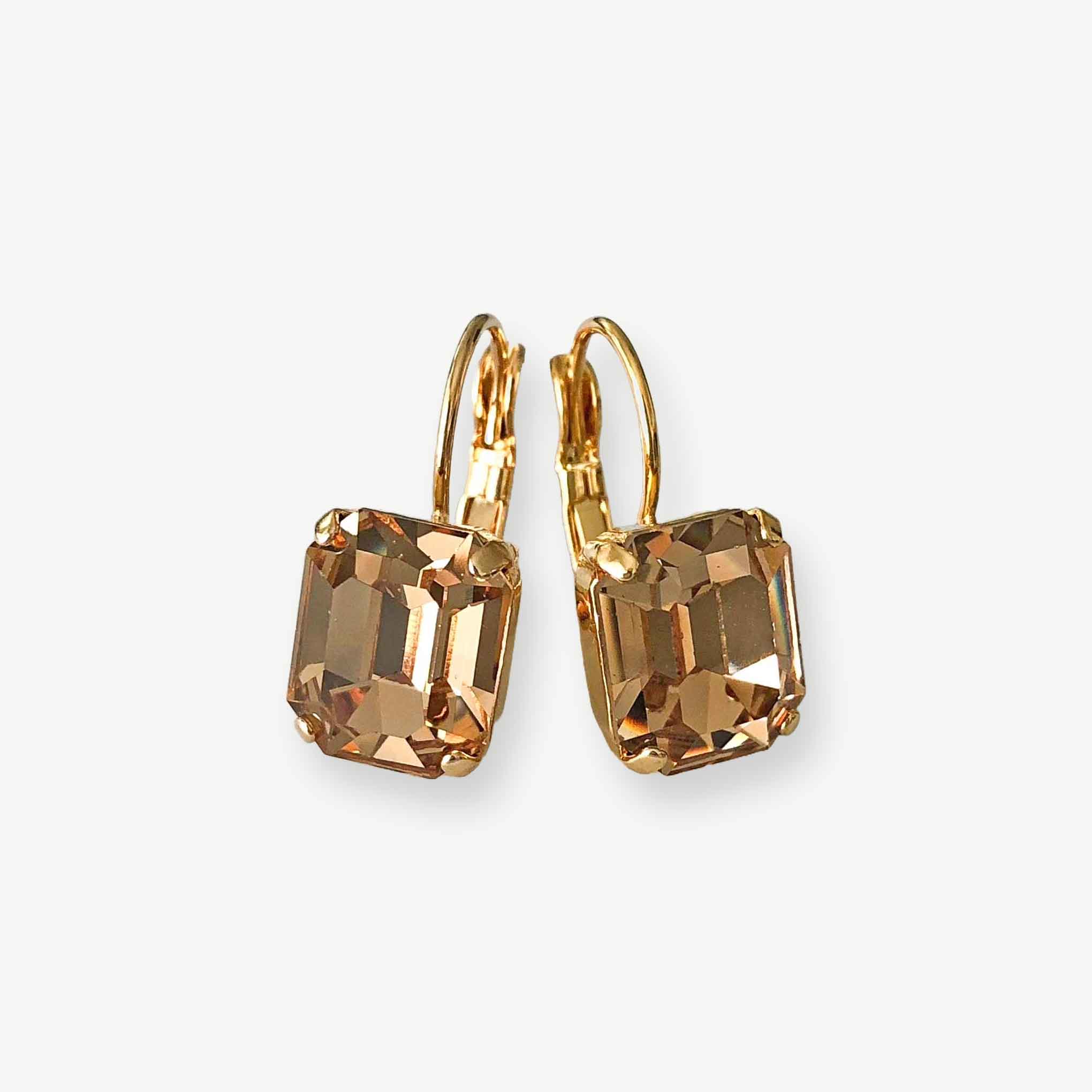 Emerald-cut light colorado topaz earrings shown in gold.