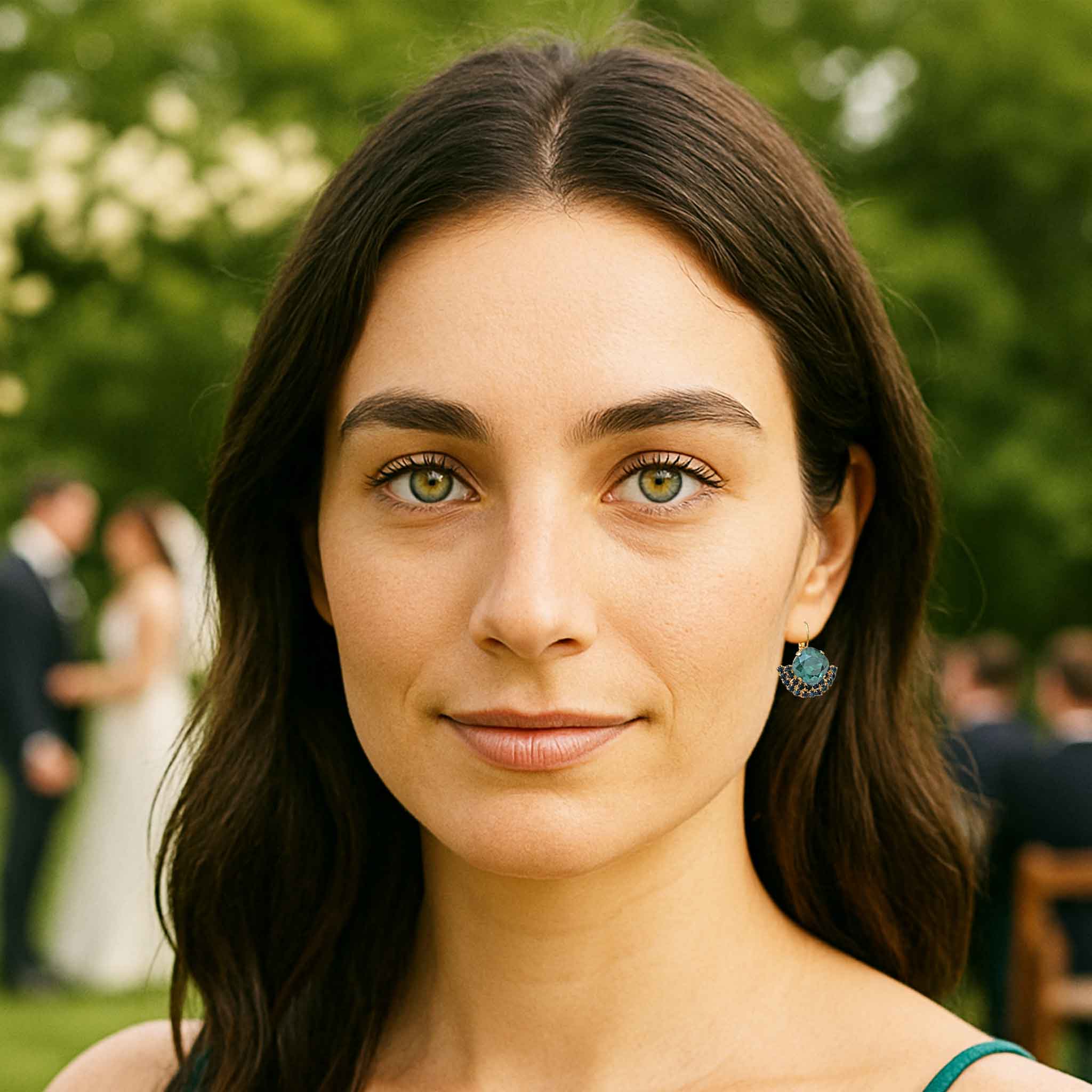 Model wearing Petite Margaux teal crystal earrings at a wedding.