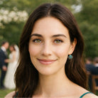 Model wearing Petite Margaux teal crystal earrings at a wedding.