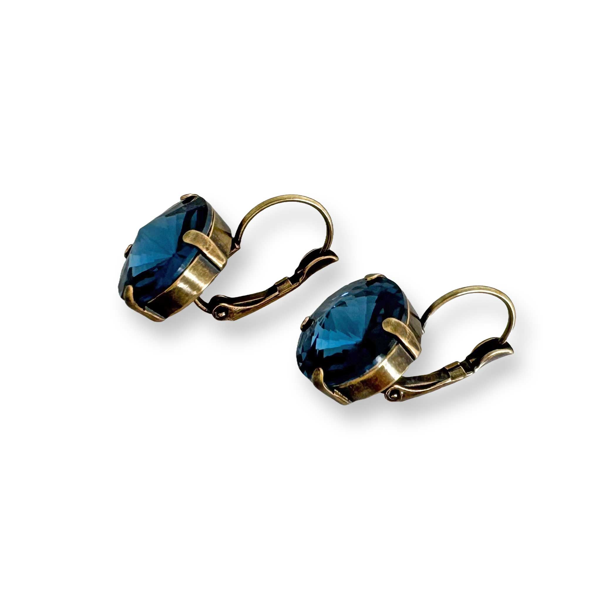 Angled view showing depth of blue crystal earrings.