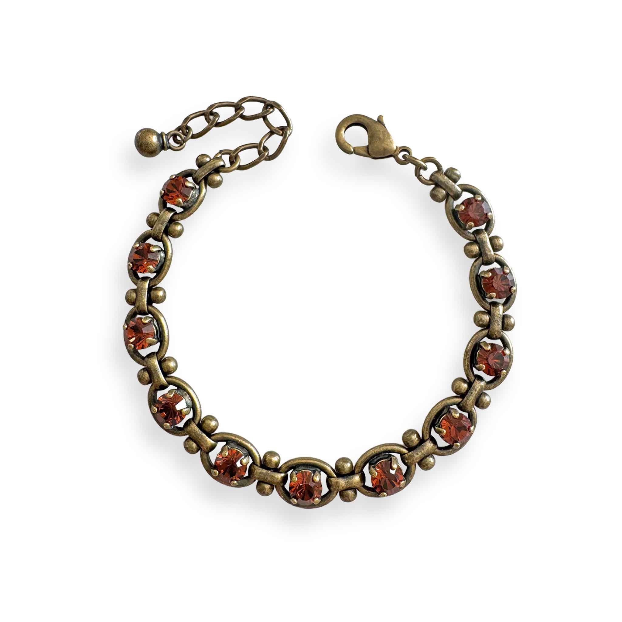 Edgy brass tennis bracelet with smokey topaz colored crystals.