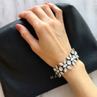 Vintage-inspired white rhinestone crystal statement bracelet shown on wrist.