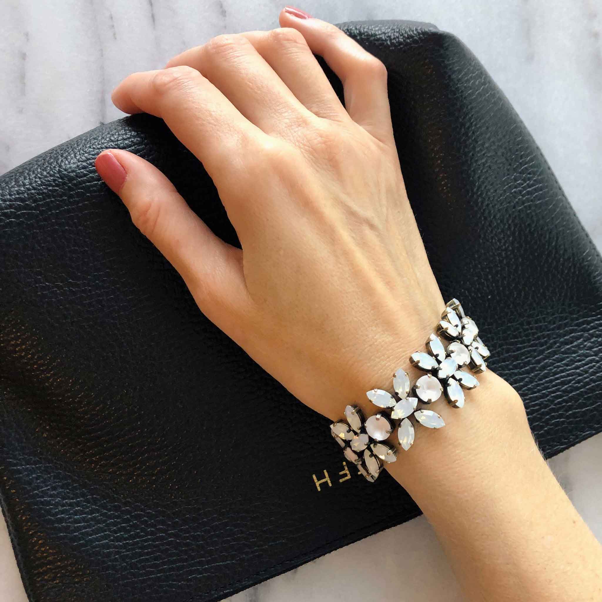 Vintage-inspired white rhinestone crystal statement bracelet shown on wrist.