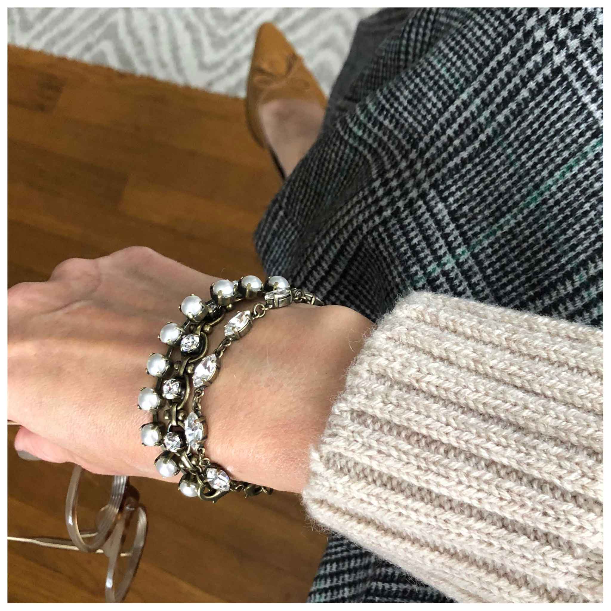 Pearl tennis bracelet shown in a stack.