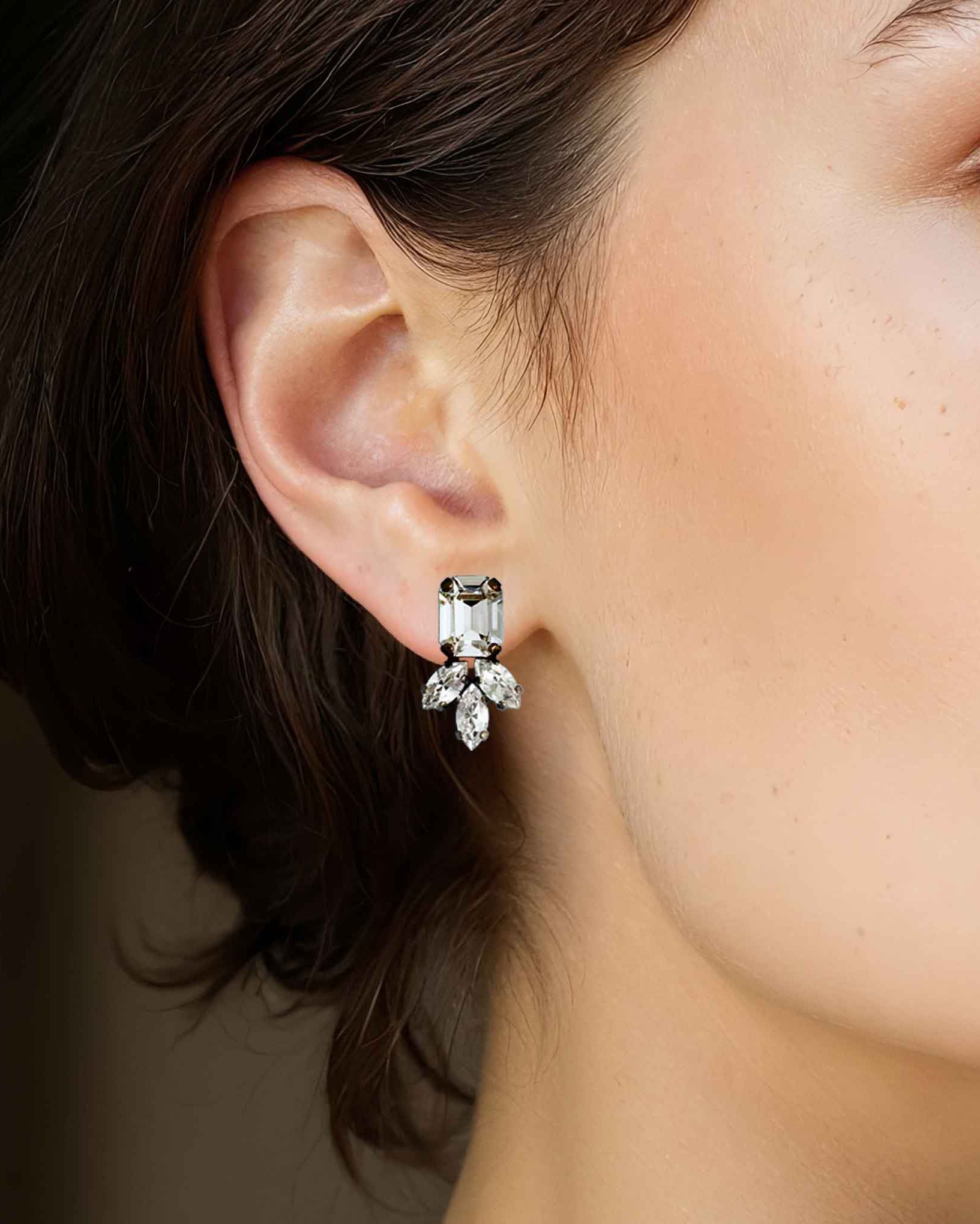 Model wearing clear crystal stud statement earrings by Petite Margaux.