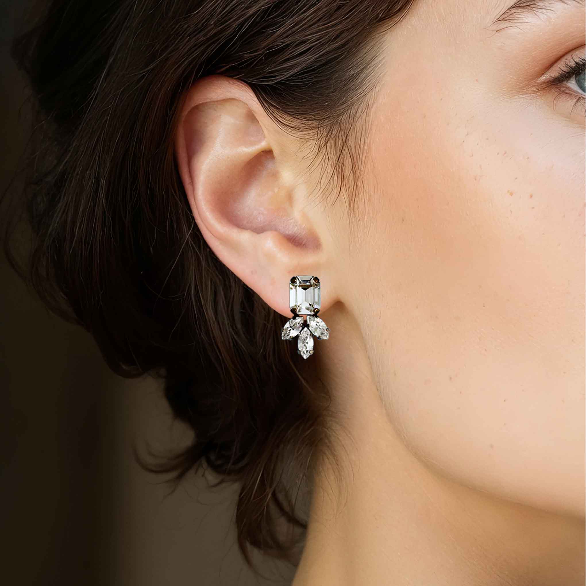 Model wearing clear crystal stud statement earrings by Petite Margaux.