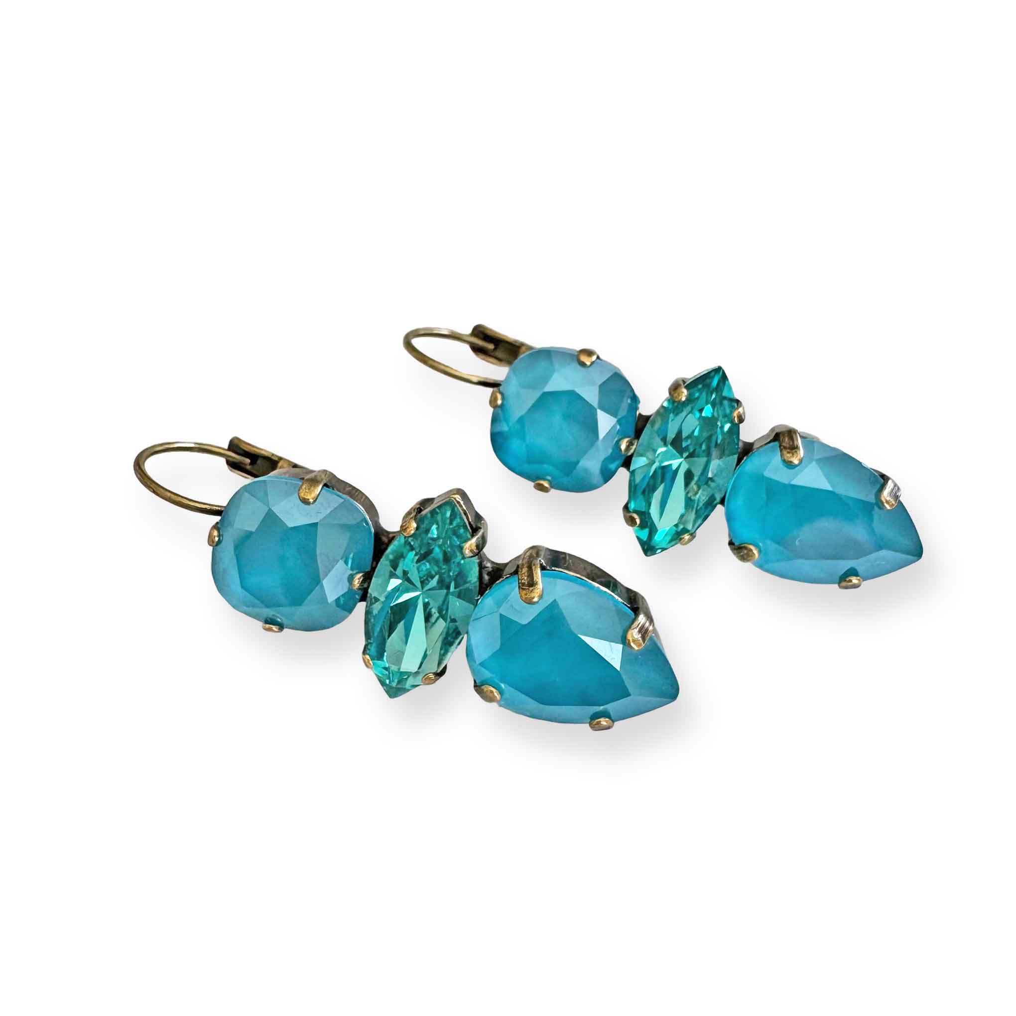 Side view of aqua blue earrings featuring the stone cuts - cushion, marquise, and teardrop.