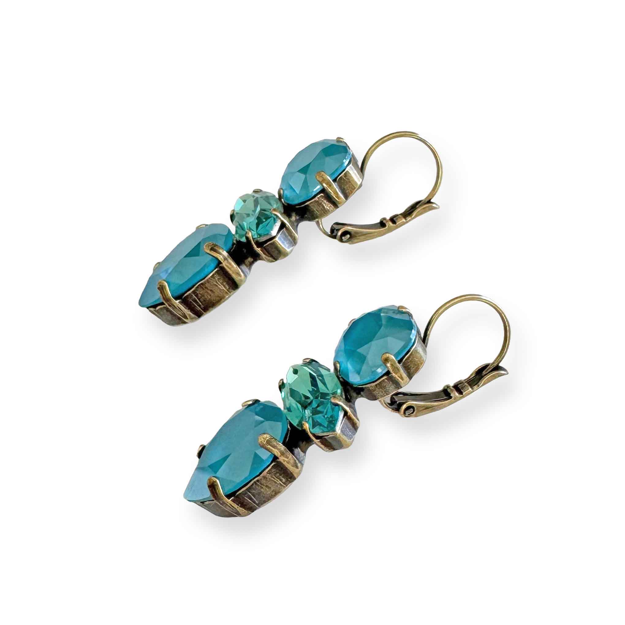Side view of turquoise blue crystal earrings showing antique brass finish.