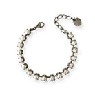 Adjustable faux pearl tennis bracelet with handset pearls in antique silver settings.