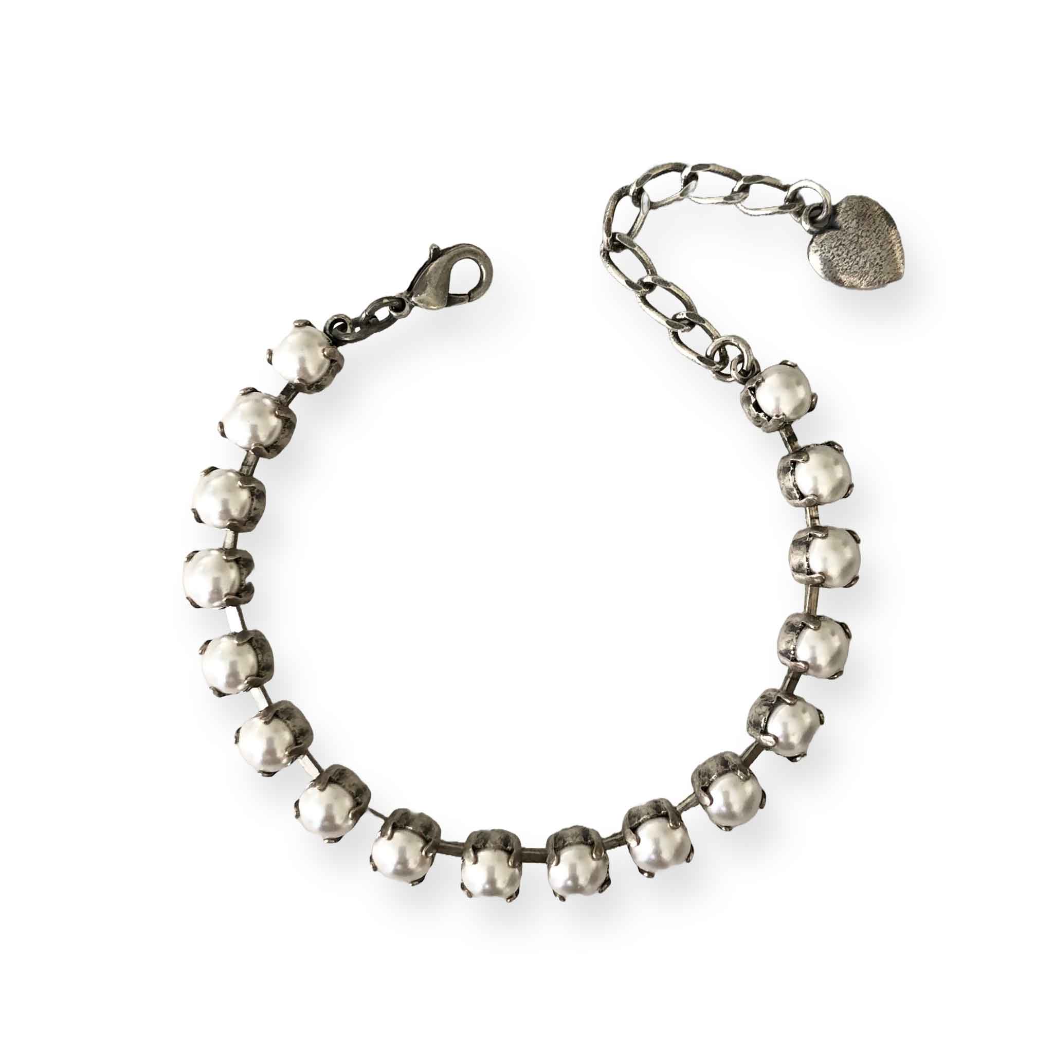 Adjustable faux pearl tennis bracelet with handset pearls in antique silver settings.