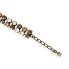 Close-up of adjustable brown, gold, white and black rhinestone bracelet shown in antique brass.