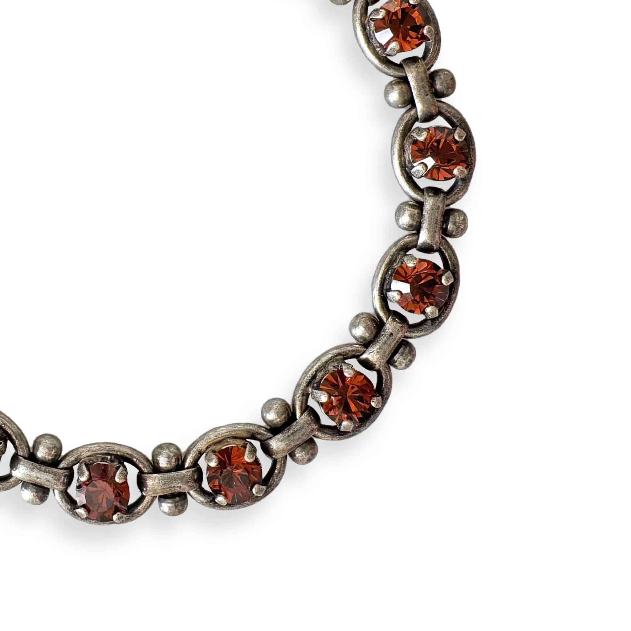 close-up of silver and dark topaz bracelet by Petite Margaux.