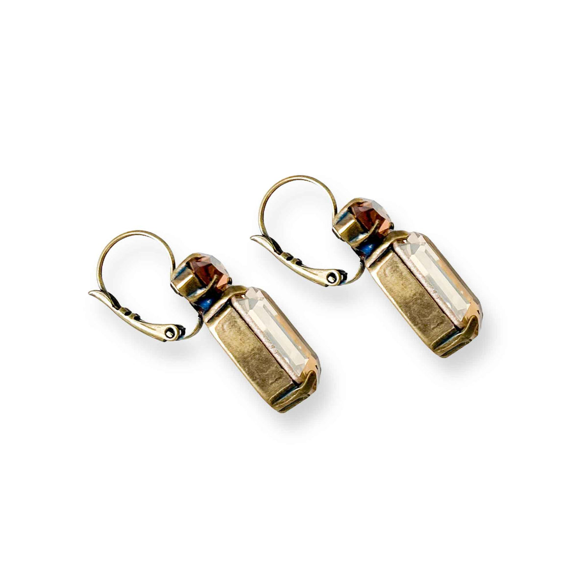 Side view of antique brass earrings with champagne and topaz colored crystal.