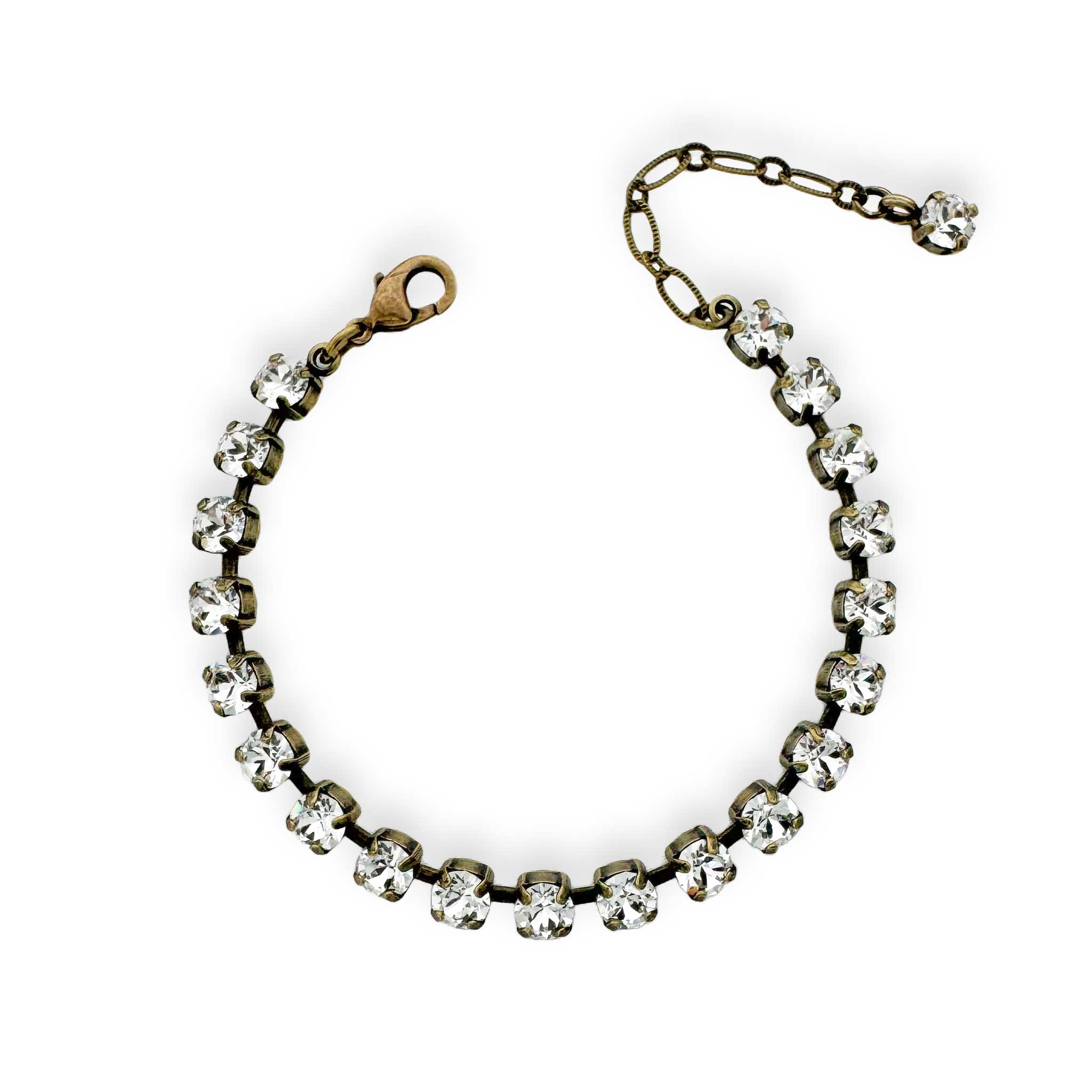 Vintage inspired clear crystal tennis bracelet with contrasting antique brass.