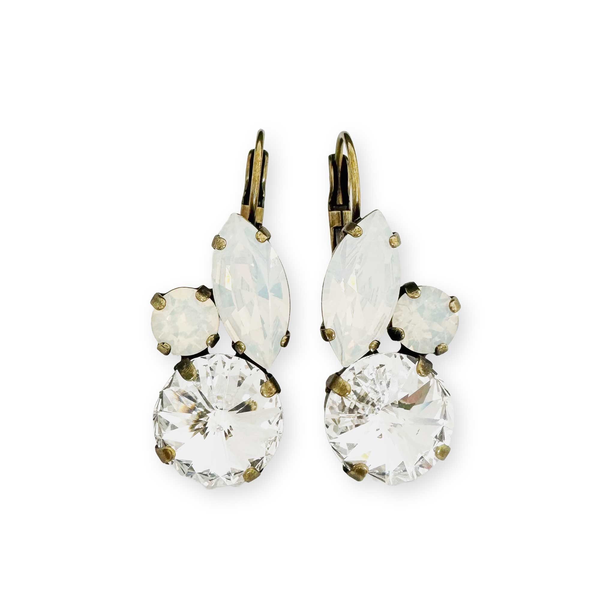 Clear and white crystal drop earrings shown in antique brass.