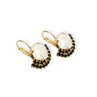 Side view of black and white crystal drop earrings in gold.