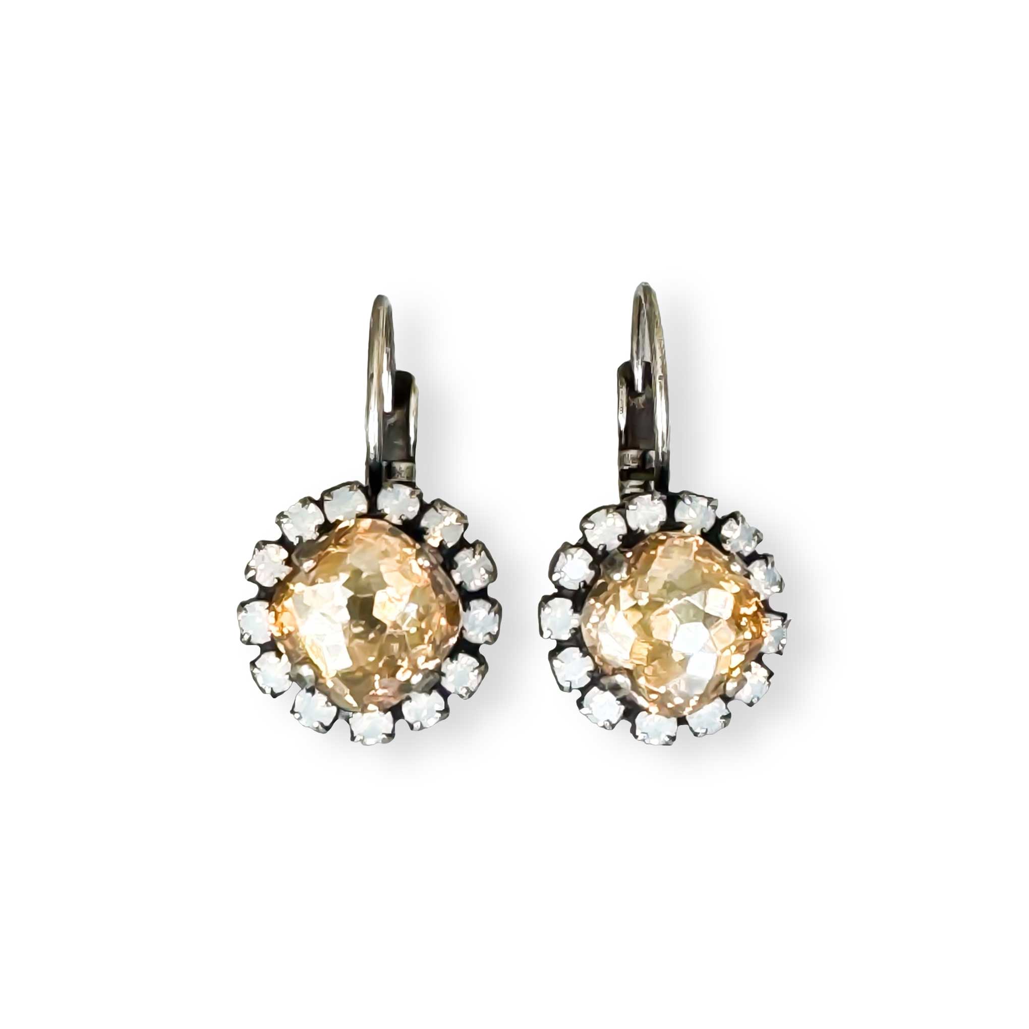 Small champagne color Austrian crystal drop earrings in silver. The earrings have a halo of small white opal crystals.